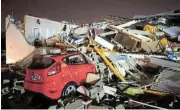  ?? /Reuters ?? Storm aftermath: A car is buried under rubble after a tornado hit Hendersonv­ille, Tennessee.