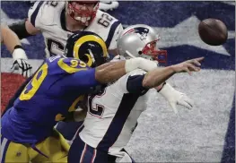 ?? CHARLIE RIEDEL — THE ASSOCIATED PRESS FILE ?? The Los Angeles Rams' Aaron Donald (99) hits the New England Patriots' Tom Brady (12) during the first half of Super Bowl 53on Feb. 3, 2019, in Atlanta. Donald has retired.
