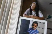  ?? CHARLIE RIEDEL / AP ?? Charron Powell with a photo of her son, LeGend Talieferro, Oct. 3 at her home in Raytown, Mo. LeGend was 4 years old when he was fatally shot June 29, 2020 while sleeping in an apartment staying with his father.