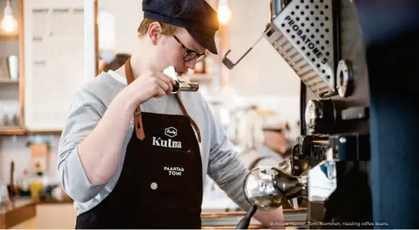  ??  ?? In-house roaster, Tomi Nieminen, roasting coffee beans.