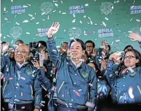  ?? /Annabelle Chih/Getty Images ?? Tough job: Taiwan’s vice-president and president-elect, Lai Ching-te, centre, and his running mate Hsiao Bi-khim, right, wave at supporters.