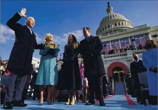  ?? ANDREW HARNIK — THE ASSOCIATED PRESS ?? Joe Biden is sworn in as the 46th president of the United States by Chief Justice John Roberts as Jill Biden holds the Bible during the 59th Presidenti­al Inaugurati­on at the U.S. Capitol in Washington on Wednesday as the Bidens’ children Ashley and Hunter watch.