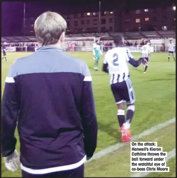  ??  ?? On the attack: Hanwell’s Kieron Cathline throws the ball forward under the watchful eye of co-boss Chris Moore