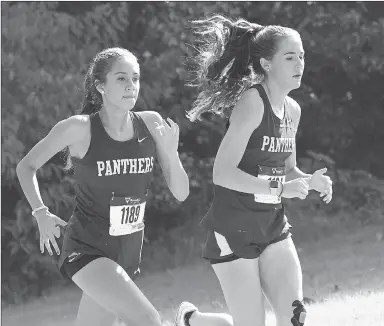  ?? Bud Sullins/Special to the Herald-Leader ?? Siloam Springs junior Chloe McGooden, left, and senior Caroline Farine run in the Panther Cross Country Classic on Saturday at the Simmons Course. McGooden was the Lady Panthers’ top runner, finishing fourth overall, and Farine placed 11th as the Lady...