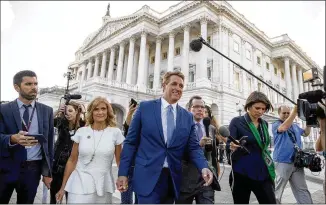  ?? ANDREW HARNIK / ASSOCIATED PRESS ?? Sen. Jeff Flake, R-Ariz., accompanie­d by his wife, Cheryl, leaves the Capitol in Washington on Tuesday after announcing that he won’t seek re-election in 2018.