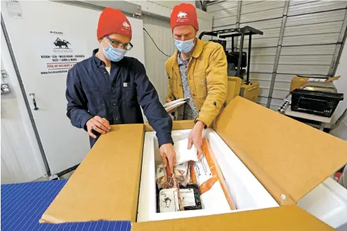  ?? PHOTOS BY LUIS SÁNCHEZ SATURNO/THE NEW MEXICAN ?? Ky Cleverley, left, Beck & Bulow warehouse manager, and J.P. Bulow, co-owner of Beck & Bulow, pack up an order for a customer last week.