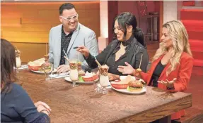  ?? ERIC MCCANDLESS/ABC ?? “Family Food Fight” judges Graham Elliot, left, Ayesha Curry and Cat Cora assess the meal prepared by one of the competing families.