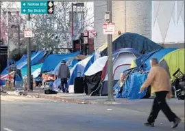  ?? Francine Orr Los Angeles Times ?? IF APPROVED, the budget for 2018-19 would allocate $374 million in Measure H funds for homeless services and prevention. Above, tents line L.A.’s skid row.