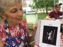  ?? BONNIE S. BENWICK, THE WASHINGTON POST ?? Circus cook Sarah Chapman with her “Simply Sarah” cookbook, open to a photo of her performing on a trapeze in 1969.