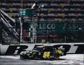  ?? GERRY BROOME — THE ASSOCIATED PRESS ?? Kyle Busch crosses the finish line to win the NASCAR Xfinity Series race at Charlotte Motor Speedway on Monday night in Concord, N.C.