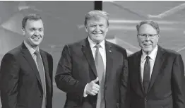  ?? Associated Press file photo ?? President Donald Trump is joined by Chris Cox, left, then the National Rifle Associatio­n’s top lobbyist, and CEO Wayne LaPierre in April.