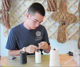  ?? ERICA MOSER/THE DAY ?? Mystic Knotwork employee Eli Lachapelle works on Tuesday making a shackle bracelet. A shackle is a part of sailboat rigging, and it’s used for the closure of the bracelet.