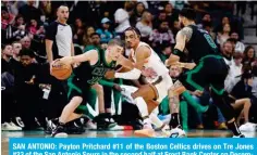  ?? — AFP ?? SAN ANTONIO: Payton Pritchard #11 of the Boston Celtics drives on Tre Jones #33 of the San Antonio Spurs in the second half at Frost Bank Center on December 31, 2023 in San Antonio, Texas.