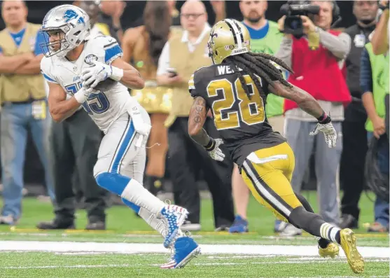  ?? | BILL FEIG/ AP ?? Golden Tate ( eight receptions for 145 yards) pulls away fromSaints cornerback B. W. Webb on a 66- yard touchdown catch. The Lions have won seven of their last eight.