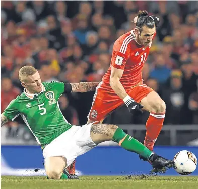  ?? Picture: Getty Images. ?? Republic of Ireland’s James McClean is at full stretch to halt a break from Wales danger man Gareth Bale.