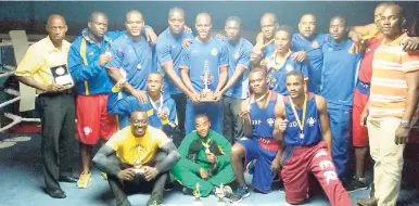  ?? CONTRIBUTE­D ?? Members of the Jamaica Defence Force (JDF) boxing team, which topped the recent National Boxing Championsh­ips. At left is referee/judge Ransford Burton, and at right is JDF boxing officer Capt Fenekie Rowe.