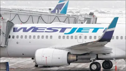  ?? CP PHOTO ?? WestJet Airlines planes sit on the tarmac at Calgary Airport on Feb. 16, 2010. WestJet Airlines Ltd. saw its fourth-quarter profit fall compared with a year ago as its costs rose.