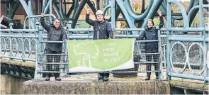  ?? PHOTO: CRT ?? Displaying the Green Flag at the Tees Barrage are, from left: Chris Gibbens, Tees Active; Reece Hugill, Canal & River Trust and Lizzie Dealey, Canal & River Trust.