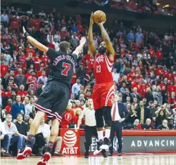  ?? (Reuters) ?? HOUSTON ROCKETS guard James Harden (13) makes a basket to tie the game late in the fourth quarter during the Rockets’ 121-117 OT victory over the Chicago Bulls at home.
