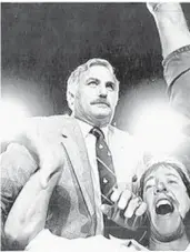  ?? DOUG JENNINGS/AP FILE ?? Miami head coach Howard Schnellenb­erger is carried off the field by Jim Kelly and others after the Hurricanes upset Nebraska in the 1984 Orange Bowl to win the state of Florida’s first college football national championsh­ip.