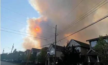  ?? Photograph: Eric Martyn/ Reuters ?? Smoke from the Tantallon wildfire rises over houses in nearby Bedford, Nova Scotia, Canada, on 28 May.