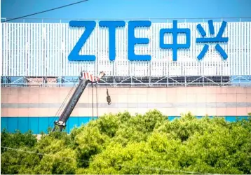  ??  ?? This picture shows the ZTE logo on an office building in Shanghai. Chinese telecom giant ZTE said its major operations had ‘ceased’ following last month’s US ban on American sales of critical technology to the company, raising the possibilit­y of its collapse. — AFP photo