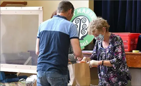  ??  ?? Emer Duffy checks out one of her first customers at the Country Market held in Ravensdale.