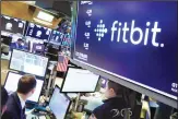  ??  ?? In this file photo, the logo for fItbit appears above a trading post on the floor of the New York Stock Exchange. Google has completed its $2.1 billion acquisitio­n of fitness-gadget maker Fitbit. (AP)