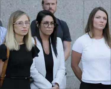  ?? SETH WENIG — THE ASSOCIATED PRESS ?? Annie Farmer, left, and Courtney Wild, right, accusers of Jeffery Epstein, stand outside the courthouse in New York, Monday. Financier Jeffrey Epstein will remain behind bars for now as a federal judge mulls whether to grant bail on charges he sexually abused underage girls.