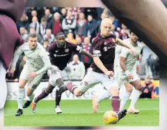  ??  ?? SPOT ON Naismith puts Hearts two up with his penalty