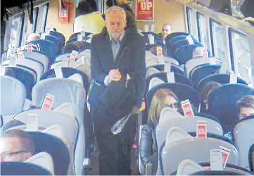  ??  ?? Footage released by Virgin showed Jeremy Corbyn walking past empty seats aboard the train