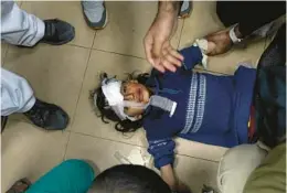  ?? ISMAEL ABU DAYYAH/AP ?? Palestinia­ns wounded in the Israeli bombardmen­t of the Gaza Strip are brought to Al Aqsa hospital in Deir al Balah, Gaza Strip, on Monday.