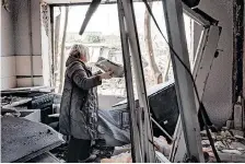 ?? AFP ?? A WOMAN collects debris to throw outside an apartment yesterday. The building in Kramatorsk was damaged by a missile amid the Russian invasion of Ukraine. |