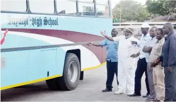  ??  ?? Former Inyathi Students Associatio­n (Fisa) member Ndumiso Gumede (second from left) marvels at a bus that was donated by the parents and Fisa during the hand over ceremony at the Bulawayo City Hall car park yesterday. On the right is the SDC chairman...