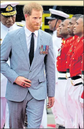  ??  ?? CEREMONY: Harry inspects the guard of honour in Fiji’s capital Suva