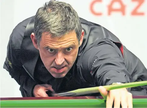  ?? ?? END OF THE WORLD: Ronnie O’sullivan lines up a shot during his quarter-final defeat to Stuart Bingham.