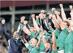  ?? REUTERS ?? Ireland’s Johnny Sexton, front, holds the trophy as he and his teammates celebrate winning the Six Nations championsh­ip.
