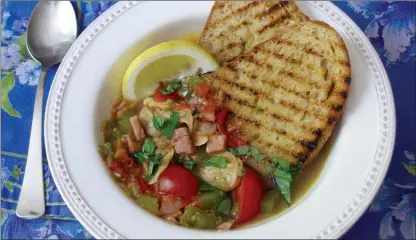  ?? Sara Moulton via AP ?? Clam, tomato and bacon stew with grilled garlic bread. This dish is from a recipe by Sara Moulton.