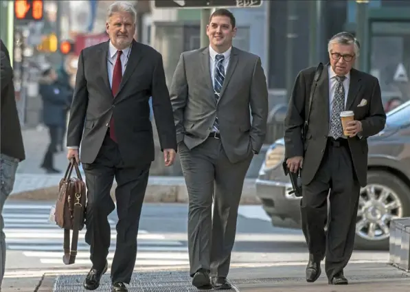  ?? Alexandra Wimley/Post-Gazette ?? From left, investigat­or Jim Smith walks with former East Pittsburgh police Officer Michael Rosfeld and defense attorney Patrick Thomassey to the Dauphin County Courthouse for the first day of jury selection in Mr. Rosfeld’s homicide trial on Tuesday in Harrisburg.