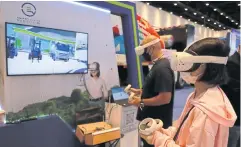  ?? SOMCHAI POOMLARD ?? People experience the metaverse during Sustainabi­lity Expo 2022. Global interest in the metaverse is growing steadily, says Mr Chumphol.