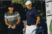  ?? DAVID J. PHILLIP – THE ASSOCIATED PRESS ?? Sergio Garcia, left, and Rory McIlroy share a laugh Wednesday during practice for the Charles Schwab Challenge.