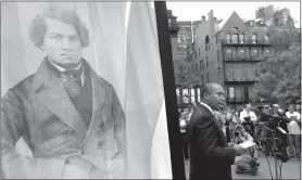  ?? STEVEN SENNE / AP FILE (2013) ?? Then-massachuse­tts Gov. Deval Patrick, right, stands next to a likeness of abolitioni­st leader Frederick Douglass while participat­ing in a community reading of the Emancipati­on Proclamati­on on July 2, 2013.