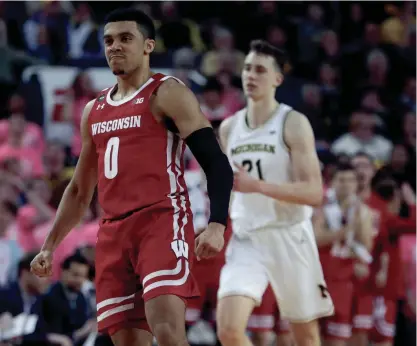  ??  ?? Wisconsin guard D'Mitrik Trice is fired up after hitting one of his 5 three-pointers Thursday night.