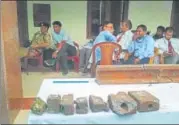  ?? HT ?? ▪ Railway employees wait for their statement to be recorded as track parts are seen in the foreground.