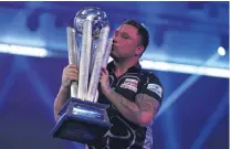  ?? PHOTO: GETTY IMAGES ?? Welsh wonder . . . Welshman Gerwyn Price celebrates with the winner’s trophy after beating Gary Anderson, of Scotland, in the final of the PDC world darts championsh­ip at Alexandra Palace in London yesterday.