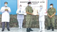  ??  ?? Dr Shamsul presenting a certificat­e of appreciati­on to one of the nurses (second right) who will be completing their assignment on December 20.