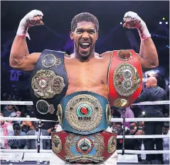  ??  ?? Just champion: Anthony Joshua is reunited with his four world title belts