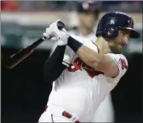  ?? TONY DEJAK — THE ASSOCIATED PRESS ?? Lonnie Chisenhall hits an RBI single off Rangers starting pitcher Cole Hamels in the fifth inning June 26 at Progressiv­e Field. Jose Ramirez scored on the play.