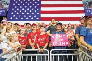  ?? Tom Brenner / New York Times ?? Supporters cheer President Donald Trump during a campaign rally in Duluth, Minn.
Many Trump voters recount undergoing something akin to a bonding experience with him.