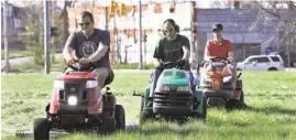  ?? AP ?? Nathan Labadie, of Commerce Township, from left, Andrew Haig, of Birmingham, and Darton Case, of Birmingham mow at Duweke Park in Detroit.